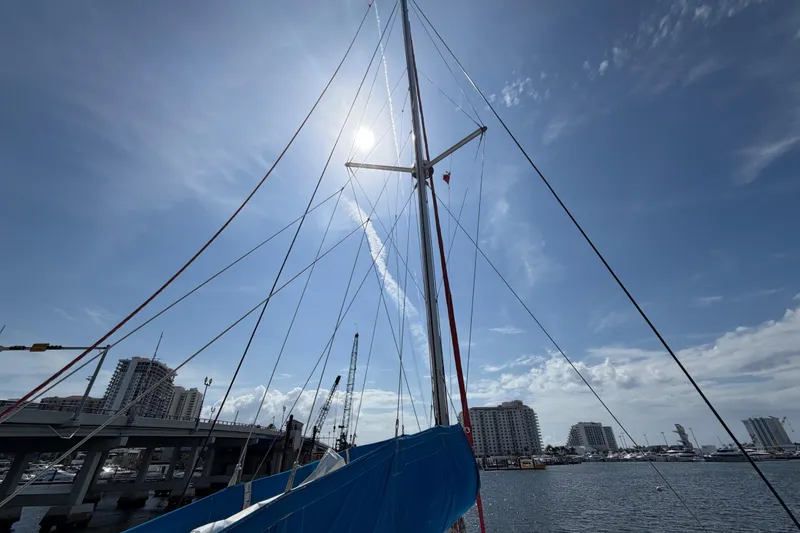 Slide: The Image of Sailboat mast of 2017 Leopard 40 against a sunny sky, docked near city buildings. - 68