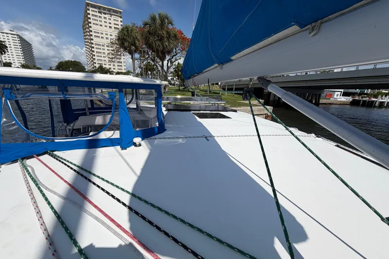 Slide: The Image of Sailing catamaran Leopard 40, 2017 model, docked near urban waterfront with blue canopy. - 70