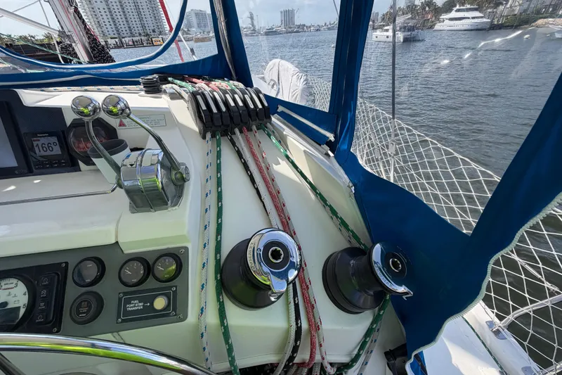 Slide: The Image of Cockpit of a 2017 Leopard 40 catamaran with control panel and winches, docked at a marina. - 78