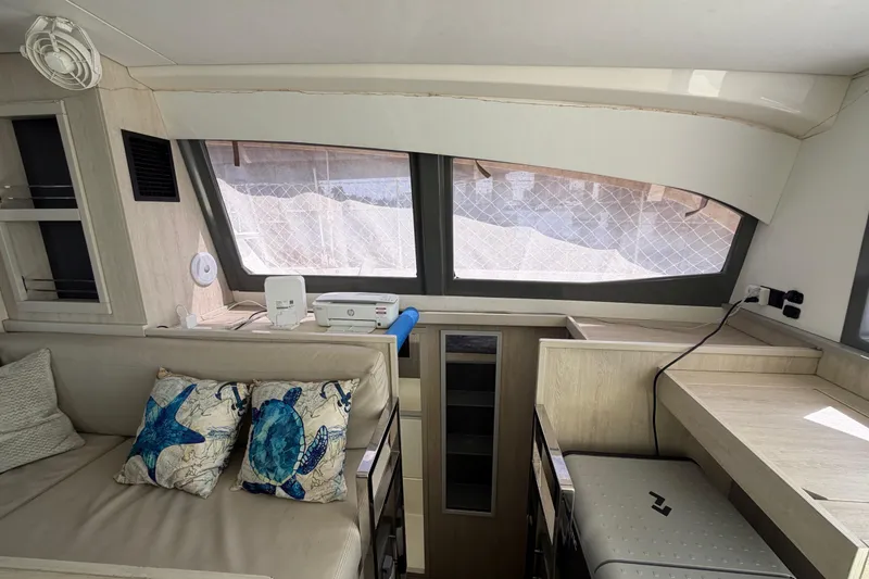 Slide: The Image of Interior of a 2017 Leopard 40 catamaran with modern furnishings and decorative pillows. - 86