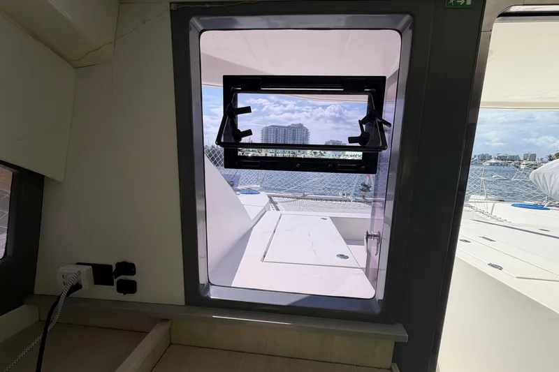 Slide: The Image of Interior view through window of 2017 Leopard 40 catamaran, overlooking marina and cityscape. - 87
