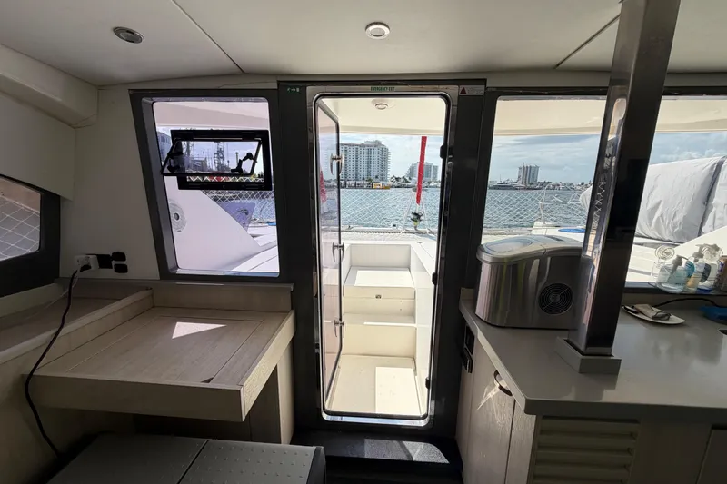 Slide: The Image of Interior view of 2017 Leopard 40 catamaran with ocean and cityscape through the door. - 88