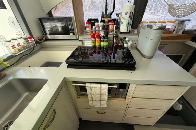 Slide: The Image of Modern kitchen in a 2017 Leopard 40 yacht with appliances and spices. - 90