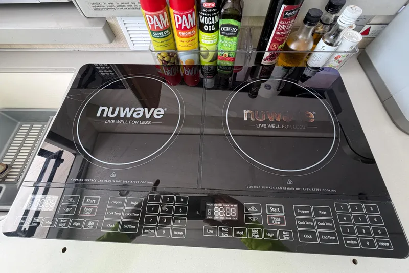 Slide: The Image of Modern kitchen with NuWave induction cooktop and assorted cooking oils. - 91