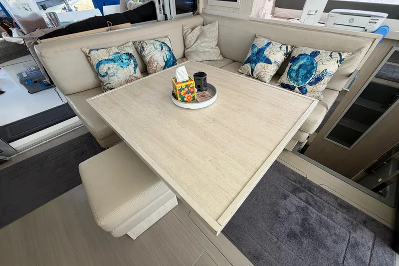 Slide: The Image of Cozy dining area in a 2017 Leopard 40 catamaran with marine-themed cushions. - 94