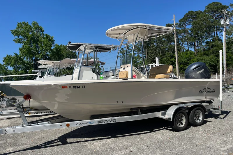 The Image of 2024 Sea Chaser 21 LX boat on trailer, featuring Yamaha engine, parked outdoors. - 0