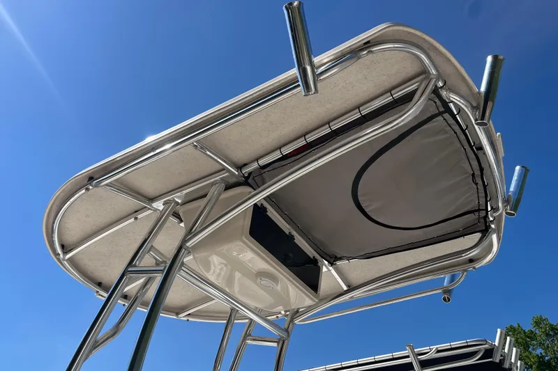 Slide: The Image of 2024 Sea Chaser 21 LX boat T-top against clear blue sky. - 10