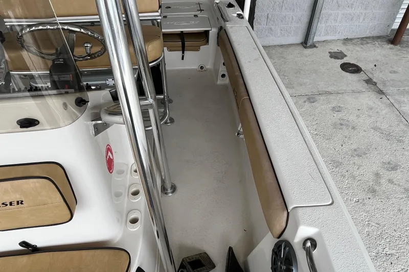 Slide: The Image of 2024 Sea Chaser 21 LX boat interior with beige seating and stainless steel fixtures. - 12