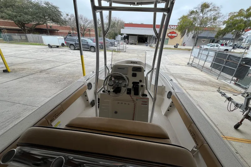 Slide: The Image of 2024 Sea Chaser 21 LX boat interior with steering console and seating. - 13