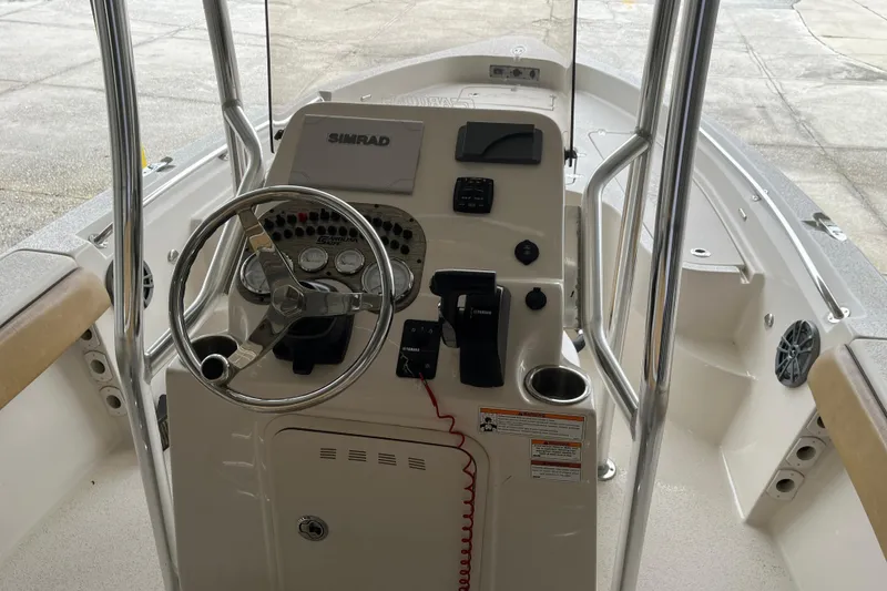Slide: The Image of 2024 Sea Chaser 21 LX boat console with steering wheel and navigation controls. - 14
