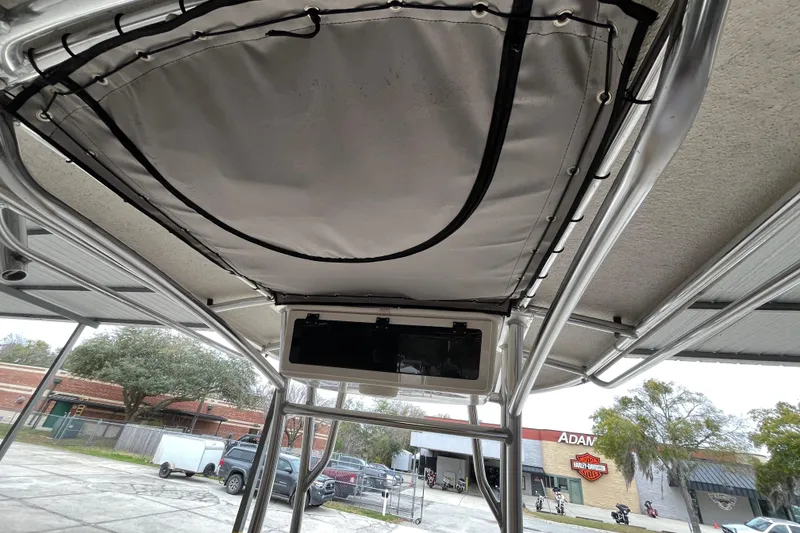 Slide: The Image of 2024 Sea Chaser 21 LX boat canopy and frame, outdoor setting. - 15