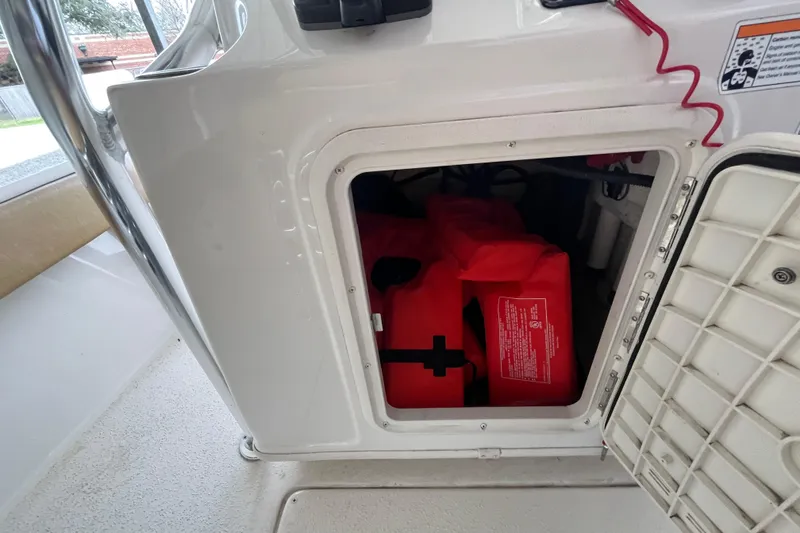 Slide: The Image of Storage compartment with life jackets on a 2024 Sea Chaser 21 LX boat. - 19