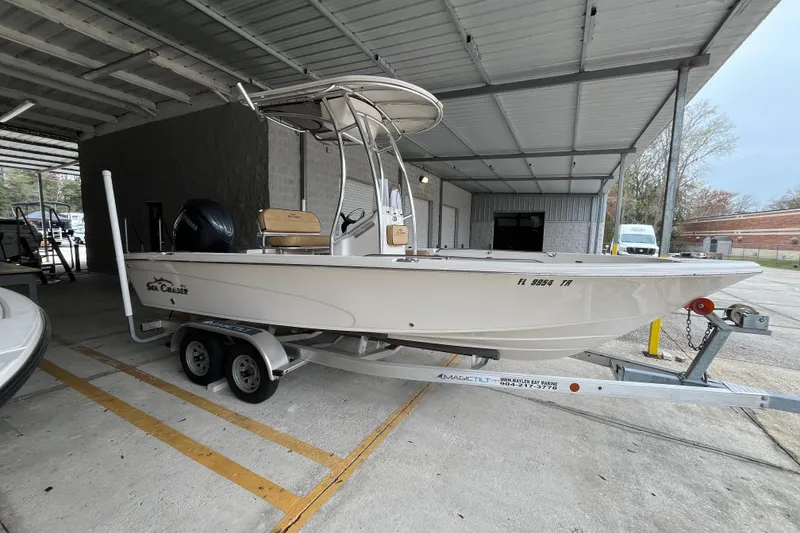 Slide: The Image of 2024 Sea Chaser 21 LX boat on trailer under a metal canopy. - 2