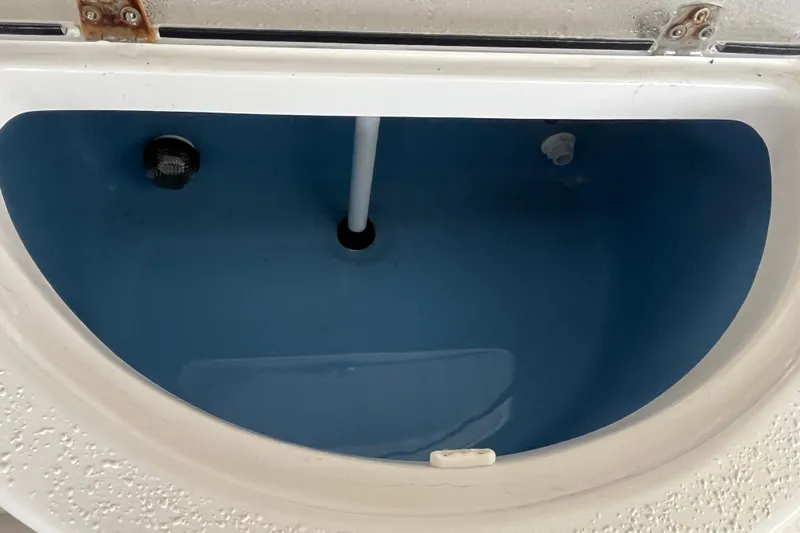 Slide: The Image of 2024 Sea Chaser 21 LX livewell interior with water and drainage system. - 21