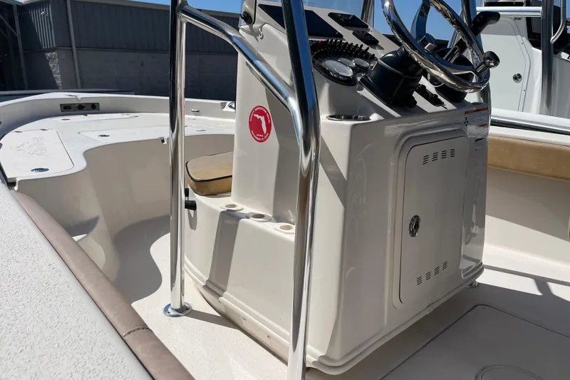 Slide: The Image of 2024 Sea Chaser 21 LX boat console with steering wheel and storage compartment. - 23