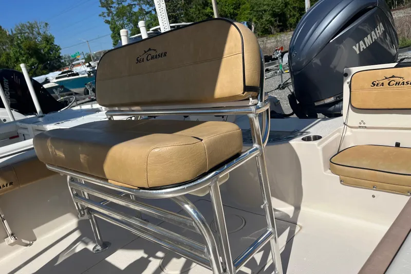 Slide: The Image of 2024 Sea Chaser 21 LX boat interior with tan seating and Yamaha engine. - 25