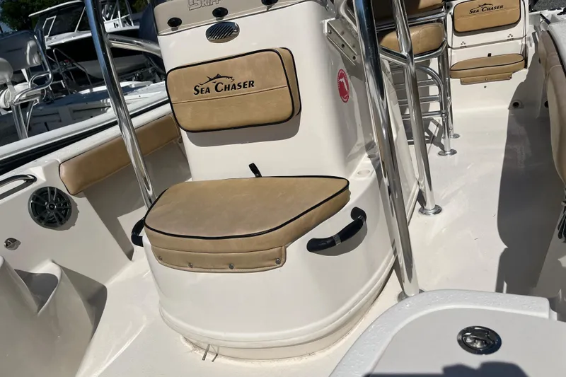 Slide: The Image of 2024 Sea Chaser 21 LX boat interior with tan seating and chrome accents. - 26