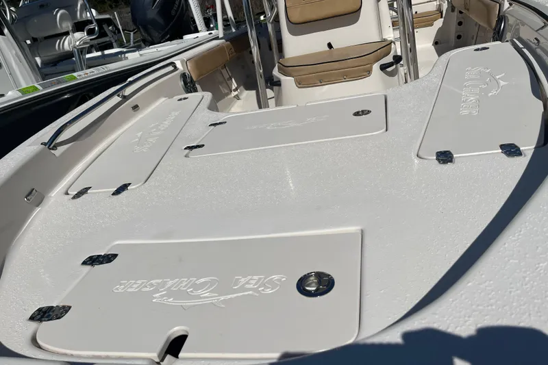 Slide: The Image of 2024 Sea Chaser 21 LX boat deck with storage compartments and seating. - 27