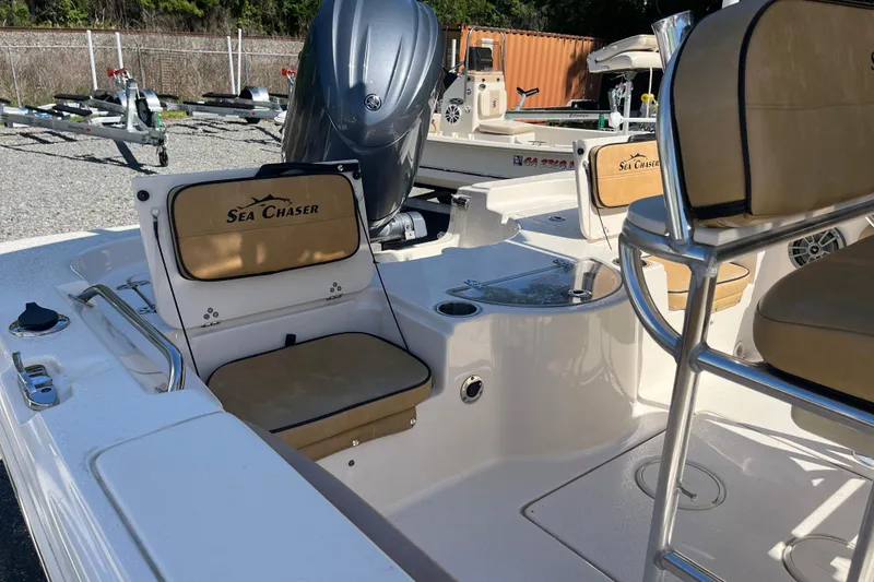 Slide: The Image of 2024 Sea Chaser 21 LX boat interior with seating and motor, showcasing luxury design. - 28