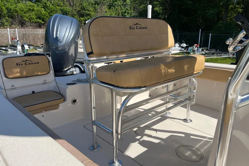 Slide: The Image of 2024 Sea Chaser 21 LX boat interior with tan seating and stainless steel fixtures. - 29