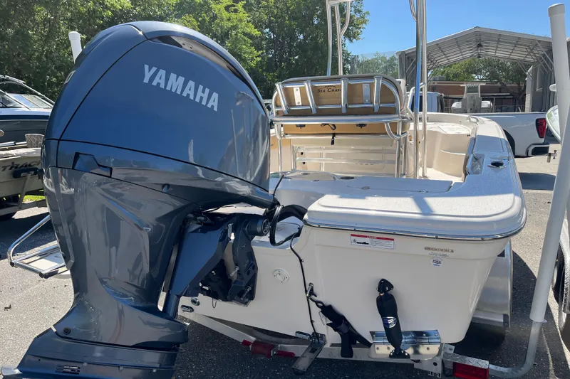 Slide: The Image of 2024 Sea Chaser 21 LX boat with Yamaha outboard motor, parked outdoors. - 5