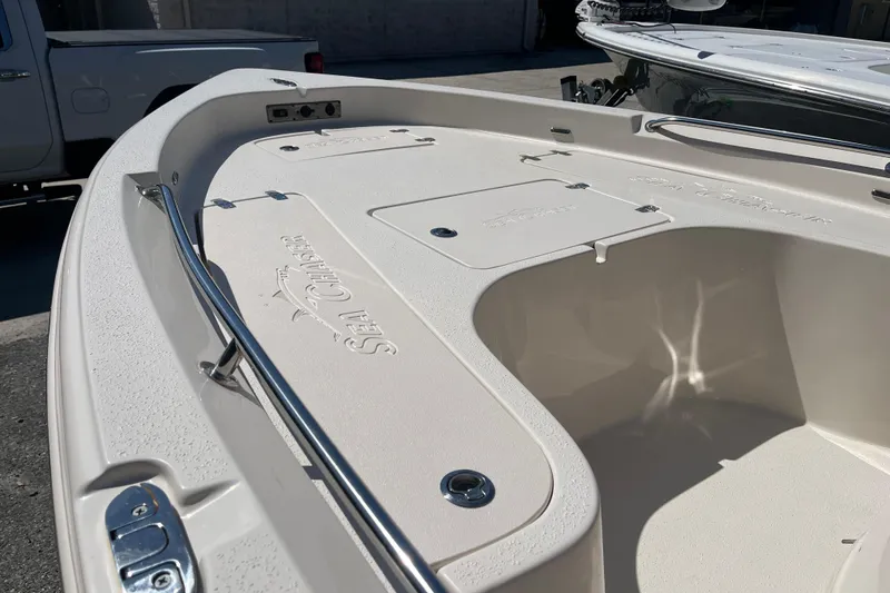 Slide: The Image of 2024 Sea Chaser 21 LX boat deck with storage compartments and sleek design. - 6