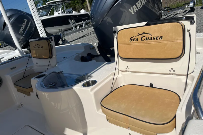 Slide: The Image of 2024 Sea Chaser 21 LX boat interior with Yamaha engine, featuring tan seating. - 8