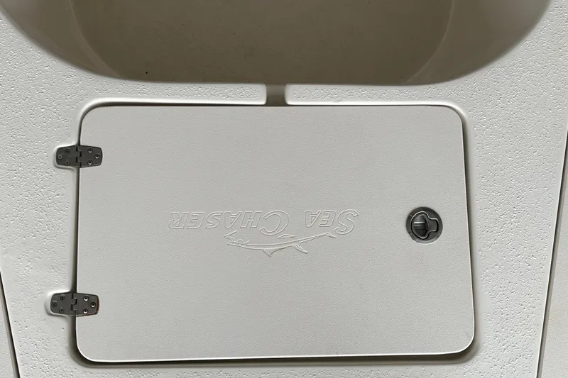 Slide: The Image of 2024 Sea Chaser 21 LX boat hatch with embossed logo and textured surface. - 9