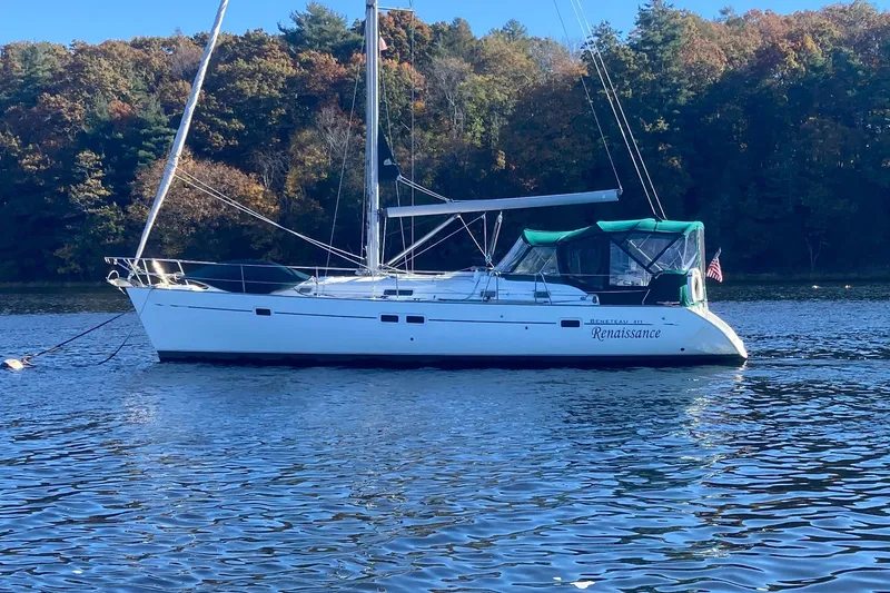 The Image of Beneteau Oceanis Clipper 411 sailboat on calm water, surrounded by autumn trees. - 0