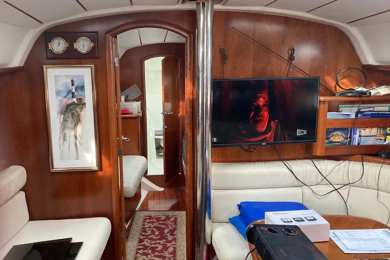 Slide: The Image of Interior of 2000 Beneteau Oceanis Clipper 411 yacht with cozy seating and wall-mounted TV. - 10