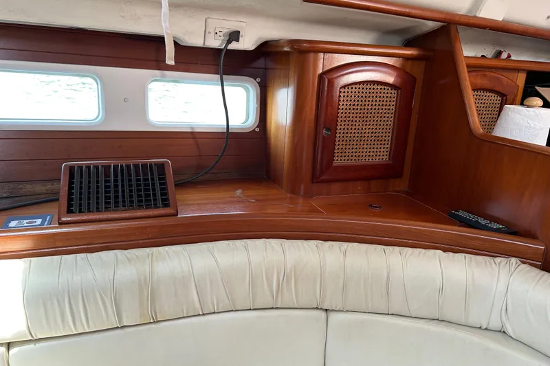 Slide: The Image of Interior of 2000 Beneteau Oceanis Clipper 411 yacht with wooden cabinetry and cushioned seating. - 15