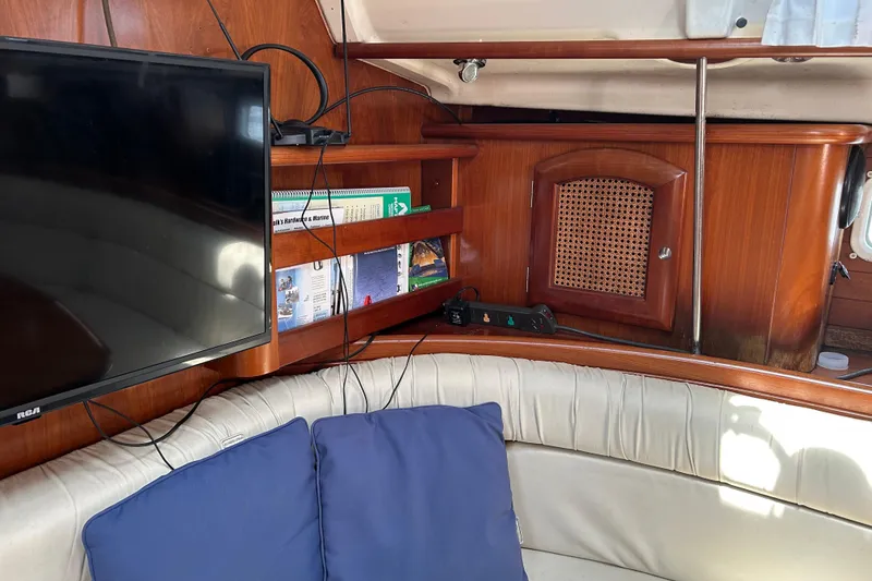 Slide: The Image of Interior of 2000 Beneteau Oceanis Clipper 411 yacht with TV and wooden cabinetry. - 16