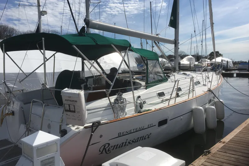 Slide: The Image of Sailboat Beneteau Oceanis Clipper 411, 2000 model, docked at marina with green canopy. - 5