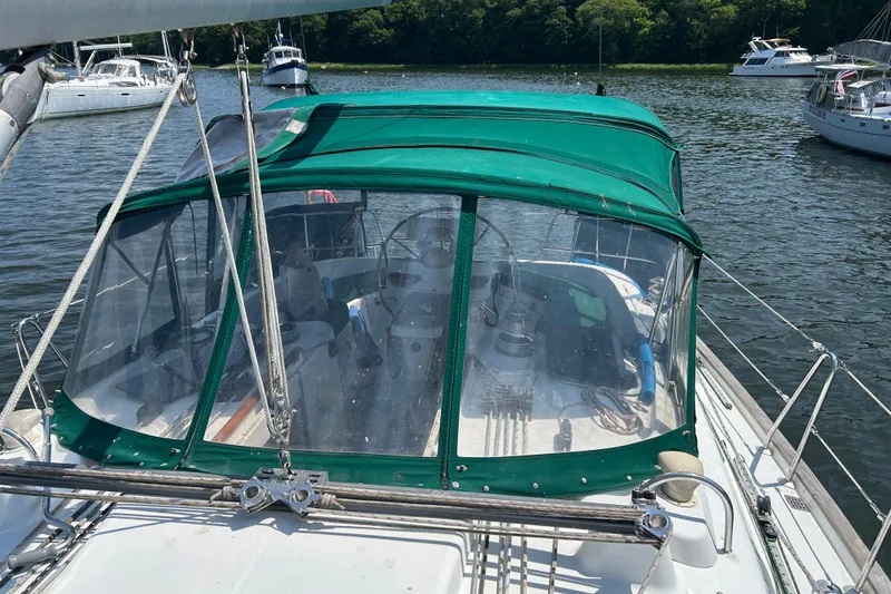 Slide: The Image of Beneteau Oceanis Clipper 411 sailboat with green canopy, docked on a sunny day. - 6