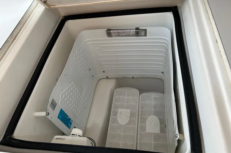 Slide: The Image of Beneteau Oceanis Clipper 411 (2000) boat refrigerator interior, open and empty. - 20
