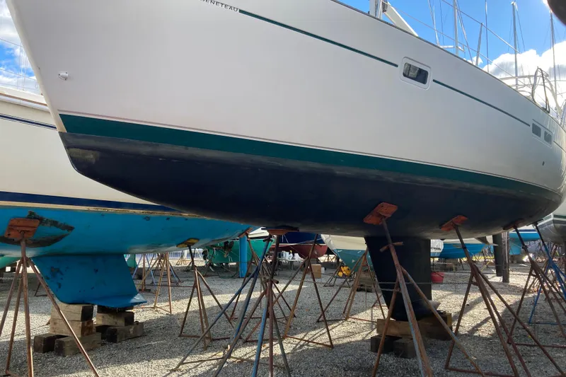 Slide: The Image of Beneteau Oceanis Clipper 411 sailboat from 2000 on stands in a boatyard. - 7