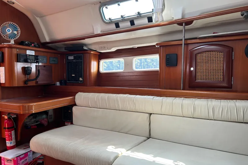 Slide: The Image of Interior of 2000 Beneteau Oceanis Clipper 411 yacht with wooden cabinetry and white seating. - 28