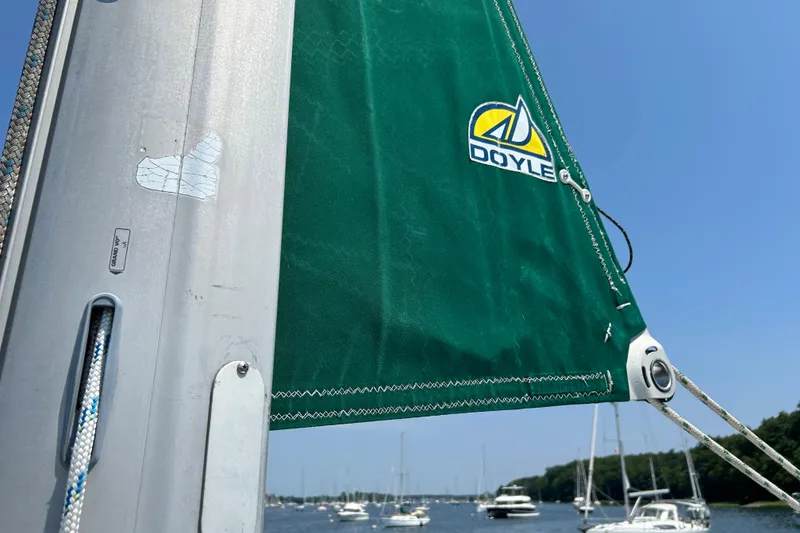 Slide: The Image of Green sail on a 2000 Beneteau Oceanis Clipper 411, featuring Doyle logo, with boats in background. - 11