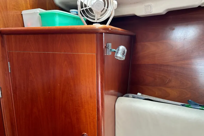 Slide: The Image of Wooden interior of 2000 Beneteau Oceanis Clipper 411 yacht with storage and fan. - 36