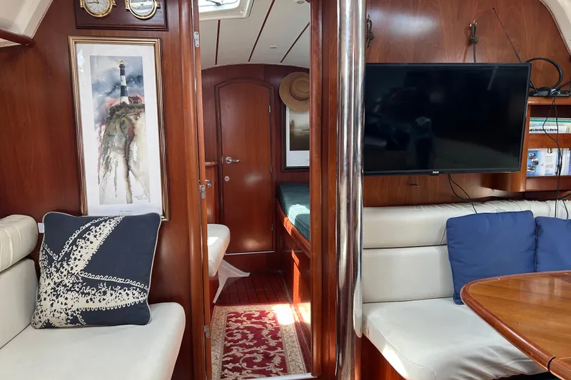 Slide: The Image of Interior of 2000 Beneteau Oceanis Clipper 411 yacht with cozy seating and nautical decor. - 14