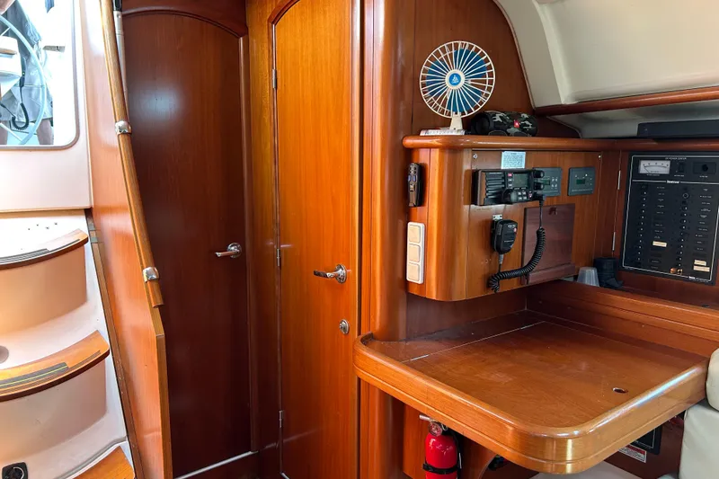 Slide: The Image of Interior of 2000 Beneteau Oceanis Clipper 411 yacht with navigation station and wooden finish. - 27