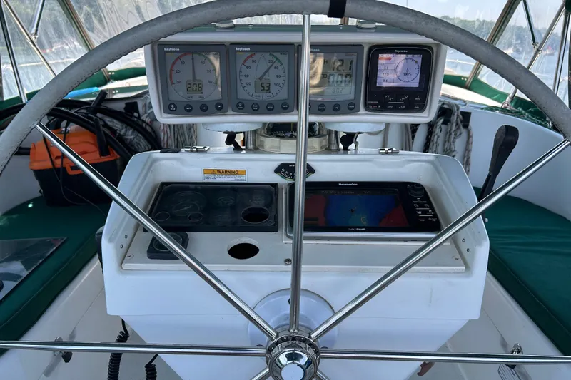 Slide: The Image of Cockpit of 2000 Beneteau Oceanis Clipper 411 with navigation instruments and steering wheel. - 43