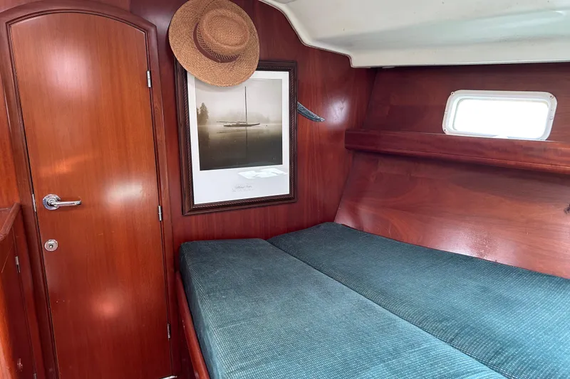 Slide: The Image of Cozy cabin interior of 2000 Beneteau Oceanis Clipper 411 with wood paneling and nautical decor. - 21