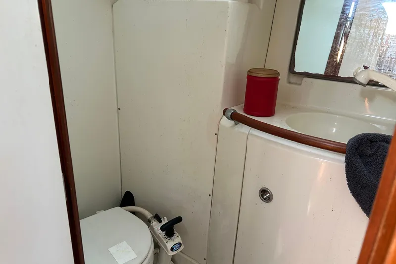 Slide: The Image of Bathroom interior of 2000 Beneteau Oceanis Clipper 411 yacht, featuring toilet and sink. - 31