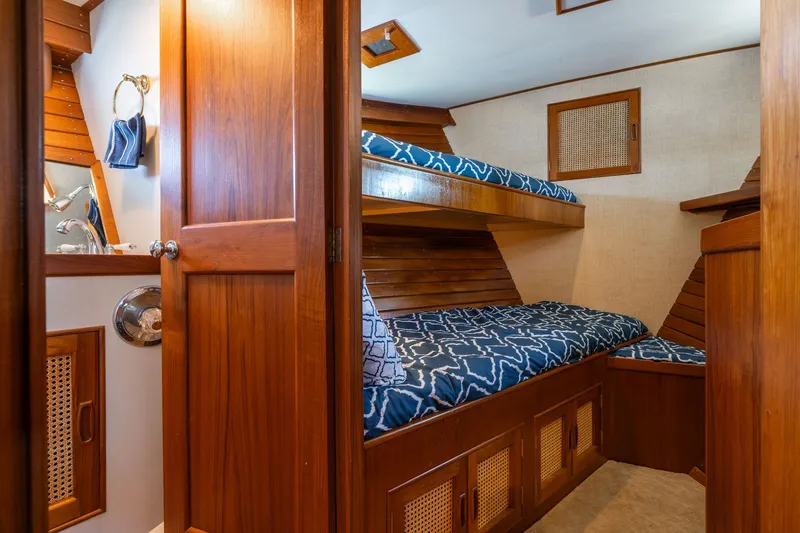 Slide: The Image of Interior of 1976 Grand Banks 52 Europa with wood finish and bunk beds. - 19
