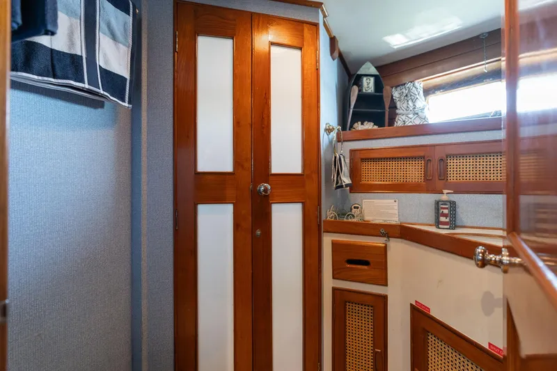 Slide: The Image of Interior of 1976 Grand Banks 52 Europa yacht with wooden doors and storage. - 23
