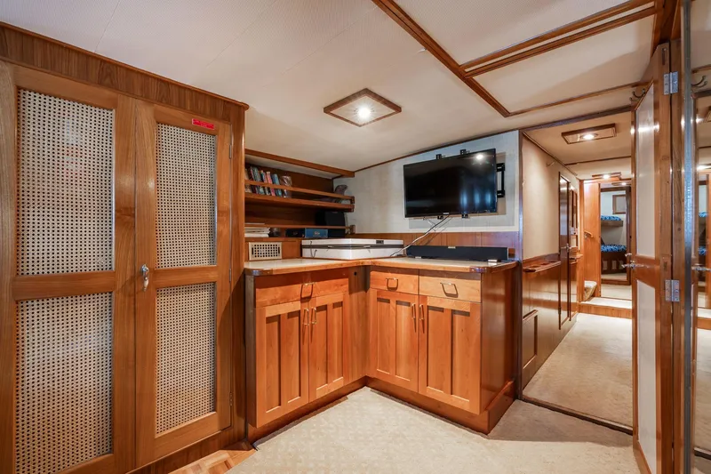 Slide: The Image of Interior of 1976 Grand Banks 52 Europa yacht with wooden cabinetry and TV. - 33