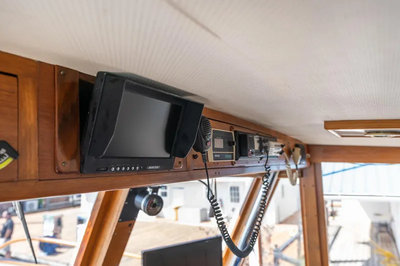 Slide: The Image of Interior of 1976 Grand Banks 52 Europa, featuring electronics and wood paneling. - 41