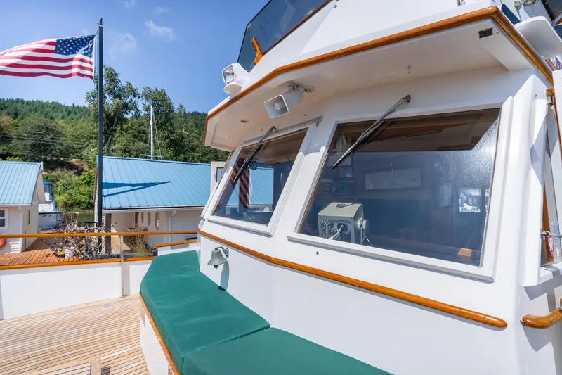 Slide: The Image of 1976 Grand Banks 52 Europa with American flag and blue sky. - 46