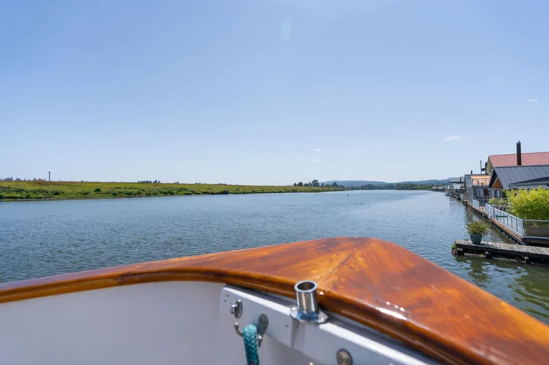 Slide: The Image of View from Grand Banks 52 Europa boat on calm river, 1976 model. - 48